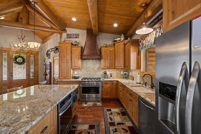 51605 Lake Mary Ronan Rd, Proctor, MT 59929 - kitchen with stainless steel appliances, custom range hood, dark wood-style floors, light stone counters, and decorative backsplash