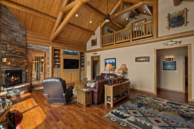 51605 Lake Mary Ronan Rd, Proctor, MT 59929 - living area featuring high vaulted ceiling, wood-type flooring, a wooden ceiling with exposed beams, a stone fireplace, and ceiling fan