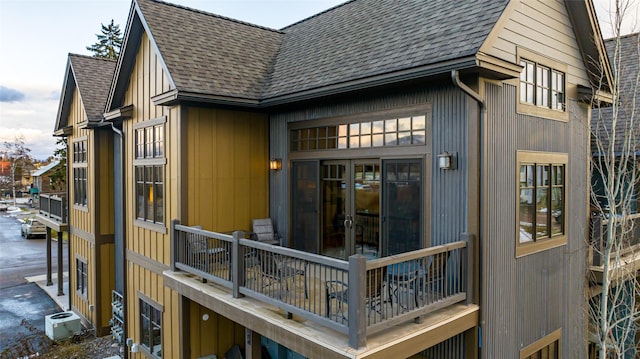 6 Obrien Ave Unit 6, Whitefish, MT 59937 - back of property featuring french doors, roof with shingles, and cooling unit