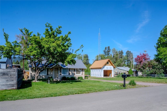 514 W 1st St, Libby, MT 59923 - view of front of house featuring a detached garage and an outbuilding