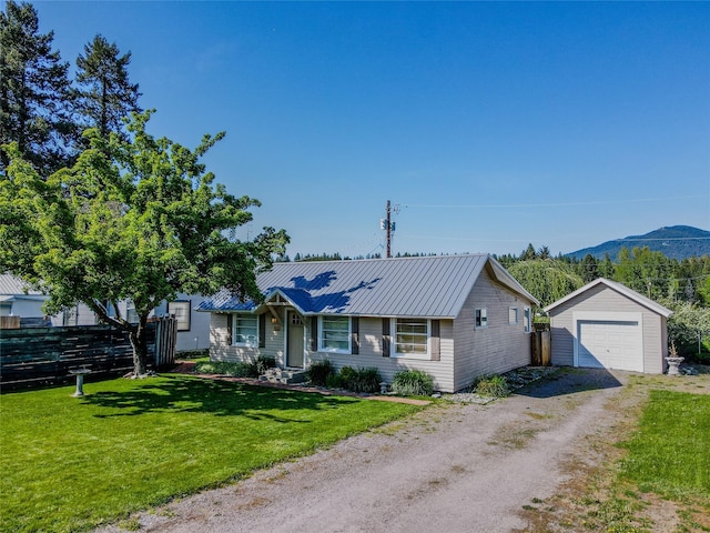 514 W 1st St, Libby, MT 59923 - ranch-style house featuring dirt driveway, an outbuilding, a detached garage, and metal roof