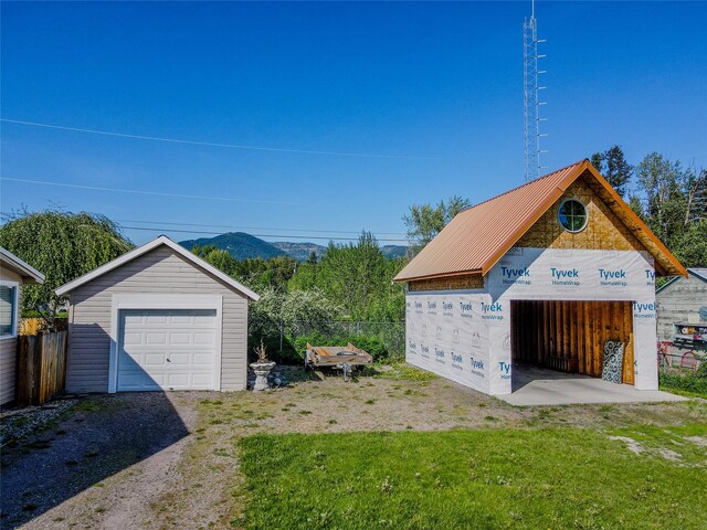 514 W 1st St, Libby, MT 59923 - detached garage with fence and a mountain view