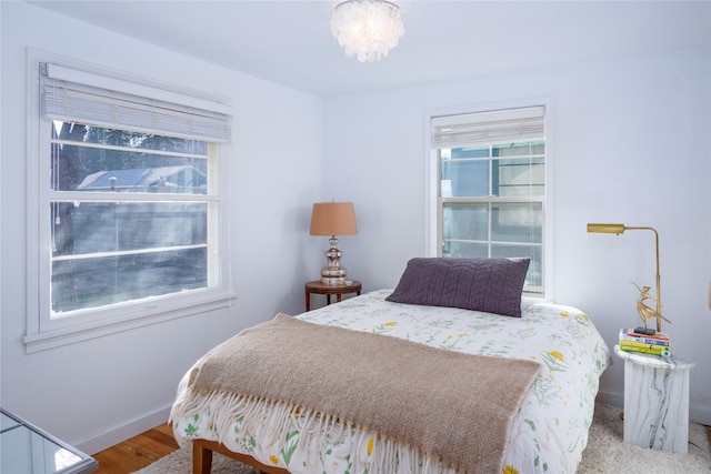 514 W 1st St, Libby, MT 59923 - bedroom with baseboards, wood finished floors, and a chandelier