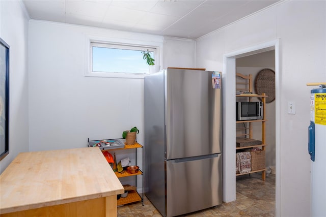 514 W 1st St, Libby, MT 59923 - kitchen with appliances with stainless steel finishes, butcher block counters, and stone finish floors