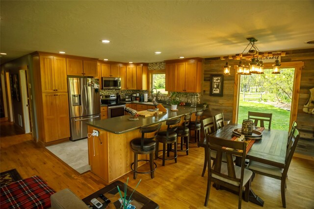 35966 Dublin Gulch Rd, Saint Ignatius, MT 59865 - kitchen featuring stainless steel appliances, light wood finished floors, brown cabinetry, a peninsula, and recessed lighting