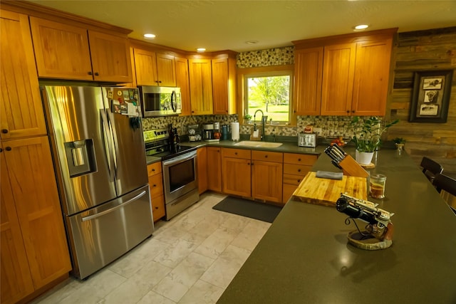 35966 Dublin Gulch Rd, Saint Ignatius, MT 59865 - kitchen with appliances with stainless steel finishes, a sink, backsplash, brown cabinetry, and recessed lighting