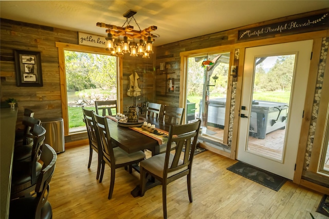 35966 Dublin Gulch Rd, Saint Ignatius, MT 59865 - dining space featuring wooden walls, a chandelier, and wood finished floors