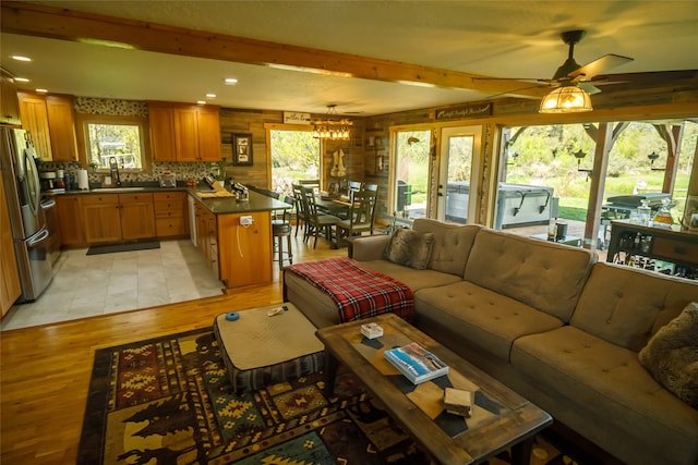35966 Dublin Gulch Rd, Saint Ignatius, MT 59865 - living area with light wood-style floors, plenty of natural light, beamed ceiling, ceiling fan, and recessed lighting