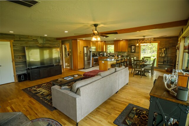 35966 Dublin Gulch Rd, Saint Ignatius, MT 59865 - living area featuring ceiling fan, light wood-style floors, recessed lighting, and wood walls