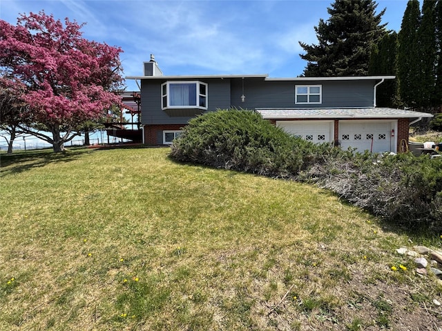 4900 Clearview Way, Missoula, MT 59803 - view of front of home featuring brick siding, a chimney, a front yard, and a garage