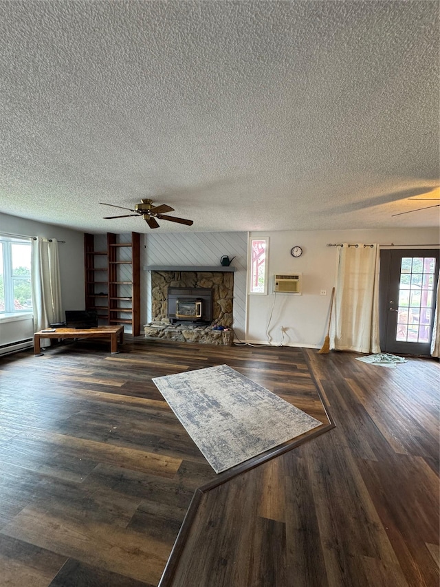 4900 Clearview Way, Missoula, MT 59803 - living room featuring a stone fireplace, a ceiling fan, plenty of natural light, wood finished floors, and a textured ceiling