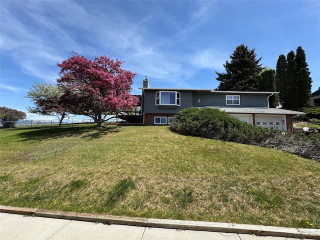 4900 Clearview Way, Missoula, MT 59803 - raised ranch featuring a chimney, brick siding, and an attached garage