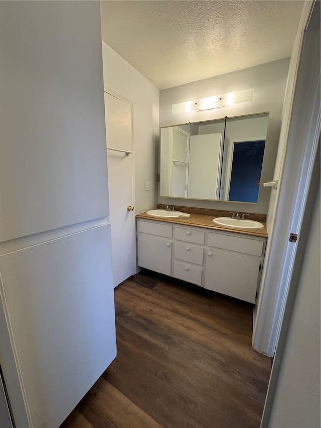 4900 Clearview Way, Missoula, MT 59803 - bathroom with wood finished floors, a textured ceiling, and double vanity