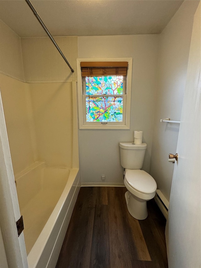 4900 Clearview Way, Missoula, MT 59803 - bathroom featuring toilet, wood finished floors, baseboards, a baseboard heating unit, and bathing tub / shower combination