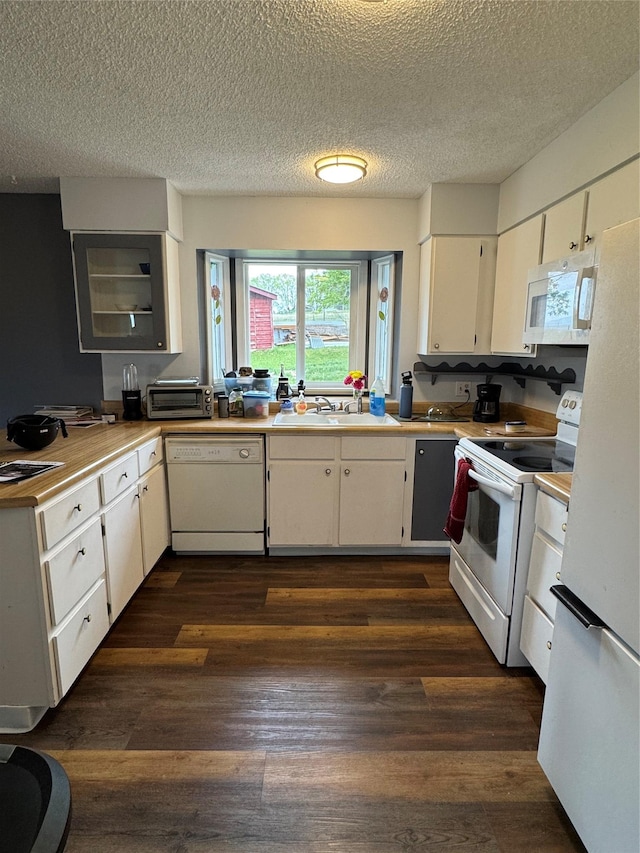 4900 Clearview Way, Missoula, MT 59803 - kitchen with white appliances, white cabinets, dark wood-style floors, a sink, and light countertops