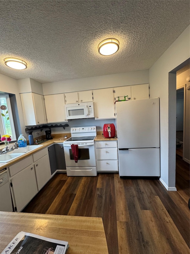 4900 Clearview Way, Missoula, MT 59803 - kitchen featuring white appliances, a sink, white cabinetry, dark wood finished floors, and a textured ceiling