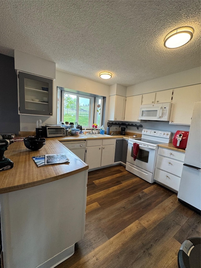 4900 Clearview Way, Missoula, MT 59803 - kitchen with white appliances, white cabinets, dark wood-style floors, a sink, and a textured ceiling
