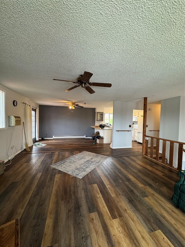 4900 Clearview Way, Missoula, MT 59803 - unfurnished living room featuring a textured ceiling, wood finished floors, a ceiling fan, and a wall mounted AC