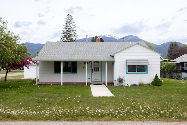 521 Buck St, Stevensville, MT 59870 - view of front of home featuring a mountain view, covered porch, and a front lawn