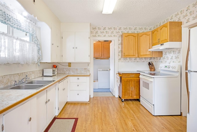521 Buck St, Stevensville, MT 59870 - kitchen featuring white electric stove, under cabinet range hood, wallpapered walls, a sink, and light countertops