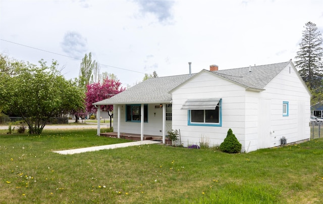 521 Buck St, Stevensville, MT 59870 - view of front of home with a shingled roof, covered porch, and a front yard