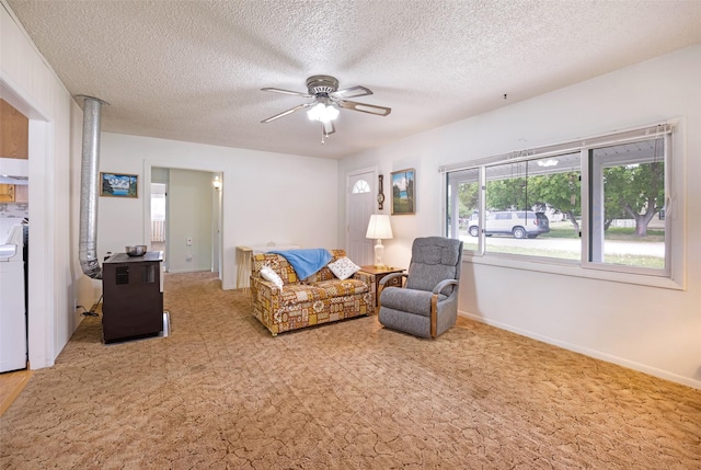 521 Buck St, Stevensville, MT 59870 - living room with carpet, a textured ceiling, a ceiling fan, and washing machine and clothes dryer