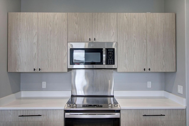 405 Trailview Way, Whitefish, MT 59937 - kitchen featuring appliances with stainless steel finishes, light brown cabinets, modern cabinets, and light countertops