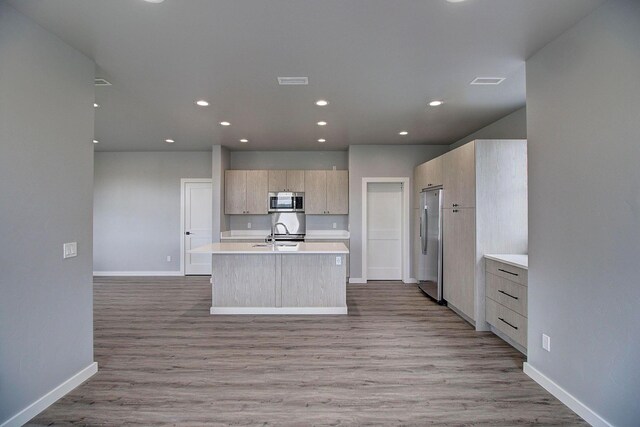 405 Trailview Way, Whitefish, MT 59937 - kitchen featuring stainless steel appliances, baseboards, a sink, light brown cabinets, and light countertops
