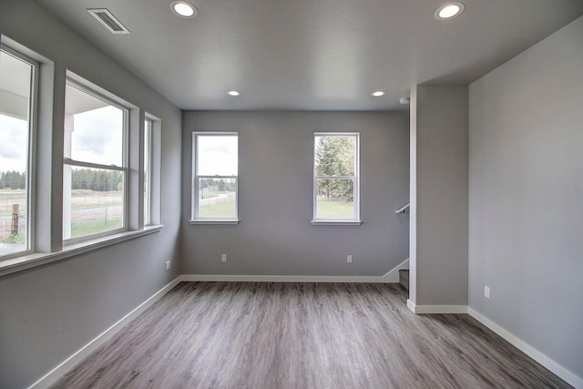 405 Trailview Way, Whitefish, MT 59937 - unfurnished room with wood finished floors, baseboards, recessed lighting, and stairway