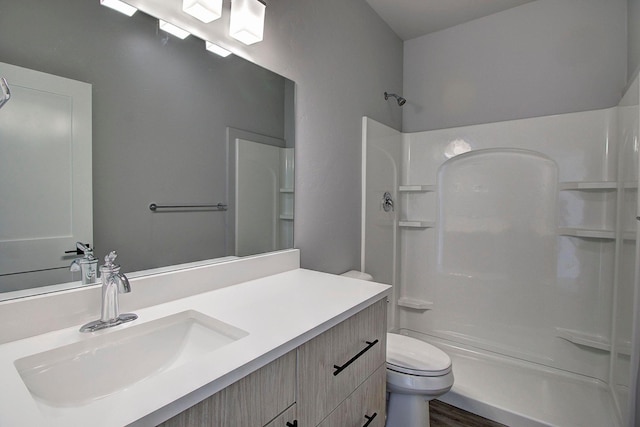 405 Trailview Way, Whitefish, MT 59937 - bathroom featuring a shower, toilet, vanity, and wood finished floors