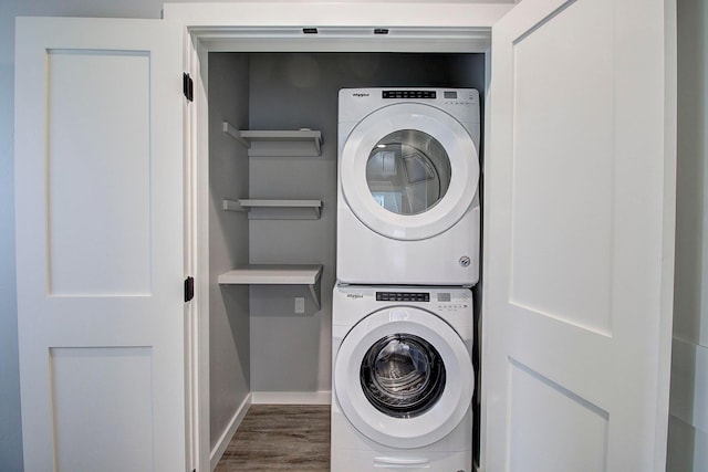 405 Trailview Way, Whitefish, MT 59937 - washroom featuring estacked washer and dryer, dark wood finished floors, and baseboards