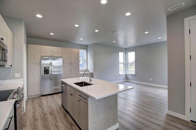 405 Trailview Way, Whitefish, MT 59937 - kitchen with a sink, stainless steel appliances, light countertops, light wood-style floors, and light brown cabinets