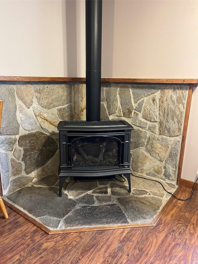 156 Clary Ave W, Geraldine, MT 59446 - detailed view of a wood stove, wood finished floors, and baseboards