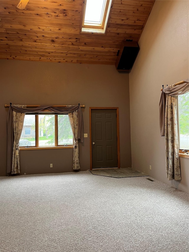 156 Clary Ave W, Geraldine, MT 59446 - carpeted empty room featuring a skylight, healthy amount of natural light, wooden ceiling, and lofted ceiling