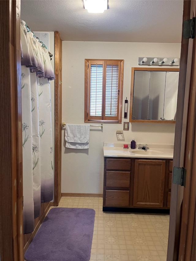 156 Clary Ave W, Geraldine, MT 59446 - full bathroom featuring vanity, a textured ceiling, a shower with shower curtain, and baseboards