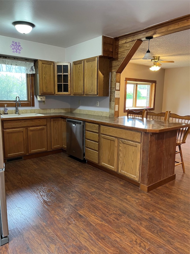 156 Clary Ave W, Geraldine, MT 59446 - kitchen featuring dishwasher, a peninsula, a sink, and dark wood-style floors