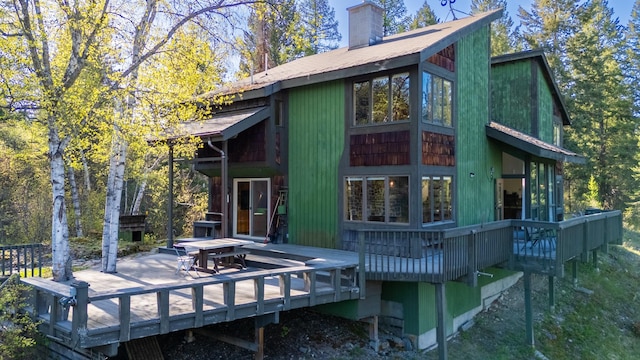 1487 Lion Mountain Dr, Whitefish, MT 59937 - back of house featuring a wooden deck and a chimney