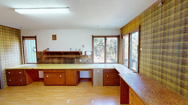 1487 Lion Mountain Dr, Whitefish, MT 59937 - kitchen with a textured ceiling, wallpapered walls, light wood-style flooring, and light countertops
