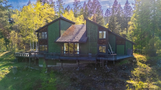 1487 Lion Mountain Dr, Whitefish, MT 59937 - rear view of property with a wooden deck and a view of trees