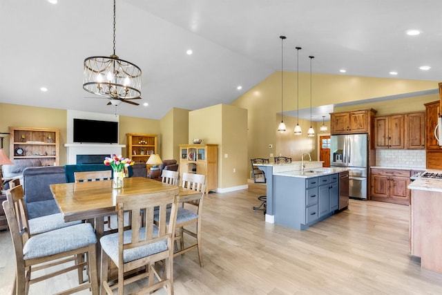 500 Bass Ln, Corvallis, MT 59828 - dining area with vaulted ceiling, light wood finished floors, a chandelier, baseboards, and recessed lighting