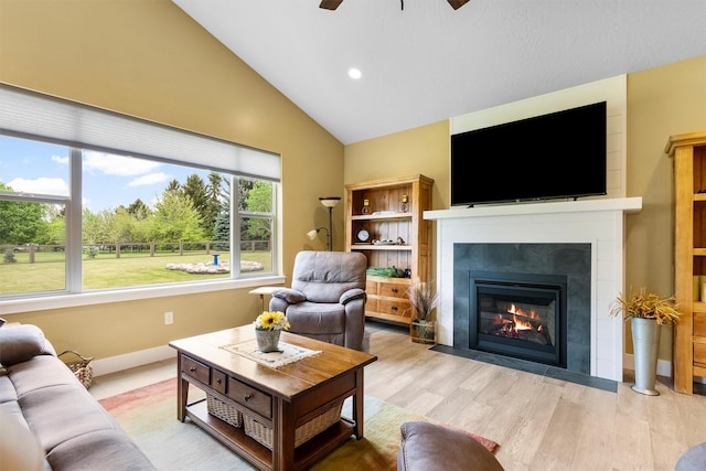 500 Bass Ln, Corvallis, MT 59828 - living room featuring a ceiling fan, a fireplace with flush hearth, light wood-style floors, high vaulted ceiling, and recessed lighting