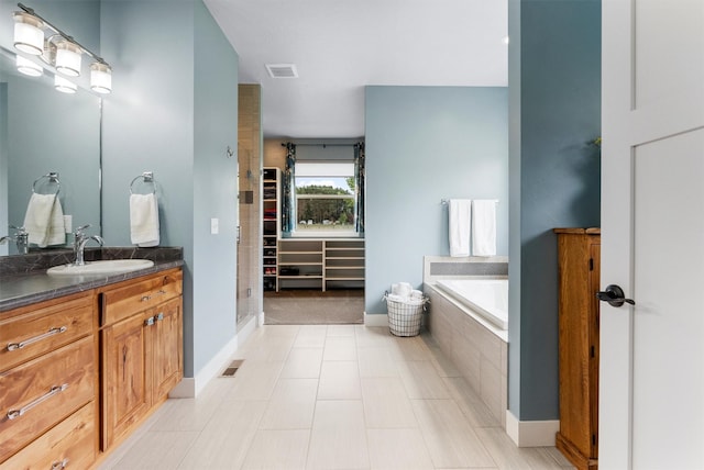 500 Bass Ln, Corvallis, MT 59828 - bathroom with vanity, a bath, and baseboards