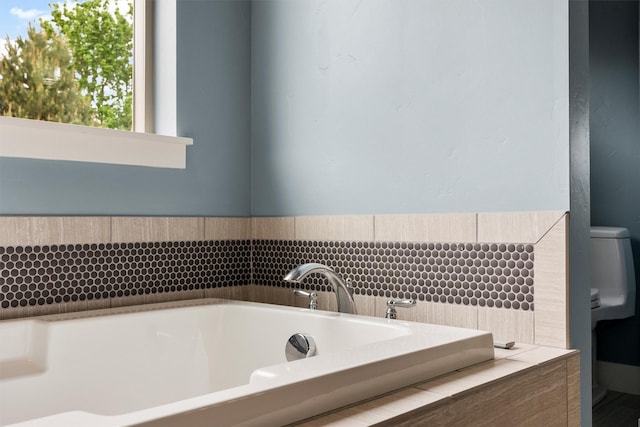 500 Bass Ln, Corvallis, MT 59828 - bathroom featuring a garden tub and toilet