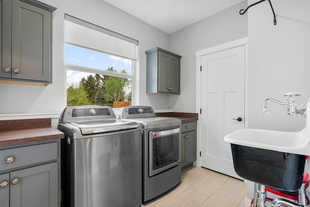 500 Bass Ln, Corvallis, MT 59828 - laundry room featuring cabinet space and washing machine and clothes dryer