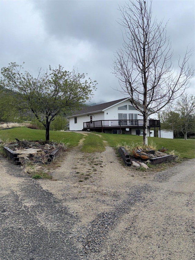 3946 E Ridge Rd, Butte, MT 59701 - view of front of house with driveway, a deck, and a front lawn