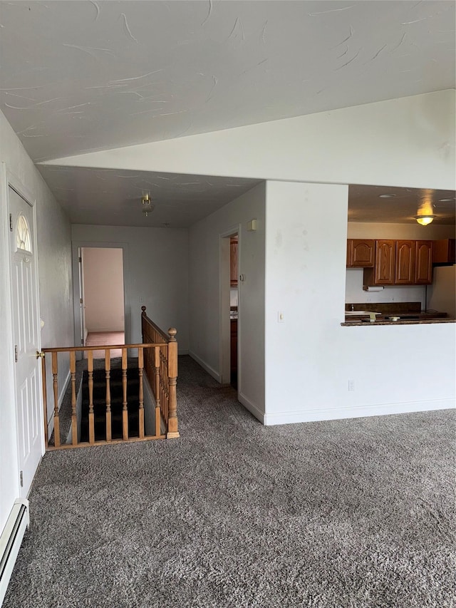 3946 E Ridge Rd, Butte, MT 59701 - carpeted empty room featuring a baseboard radiator, lofted ceiling, and baseboards