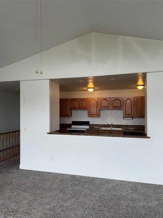 3946 E Ridge Rd, Butte, MT 59701 - kitchen featuring dark countertops, lofted ceiling, range with electric cooktop, carpet, and a sink