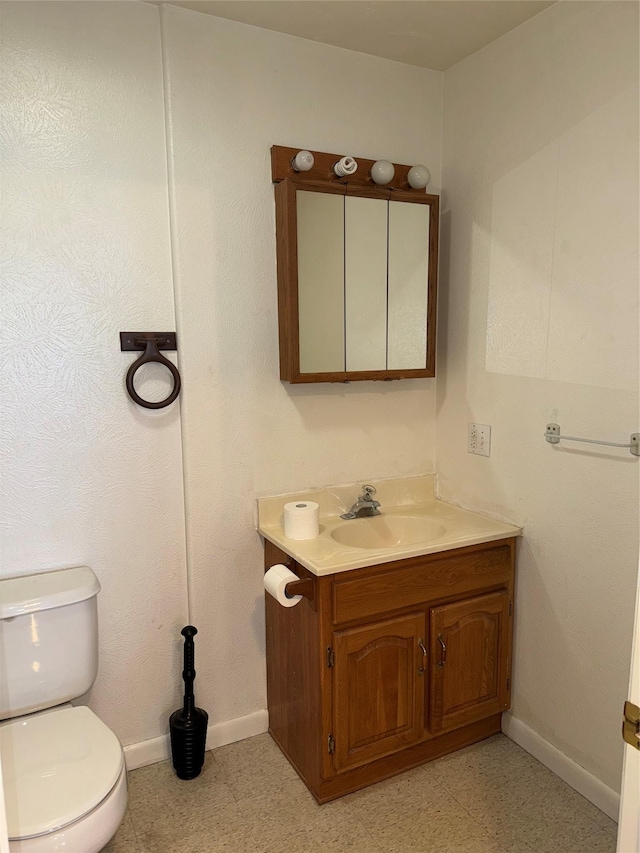 3946 E Ridge Rd, Butte, MT 59701 - half bath featuring baseboards, vanity, and toilet