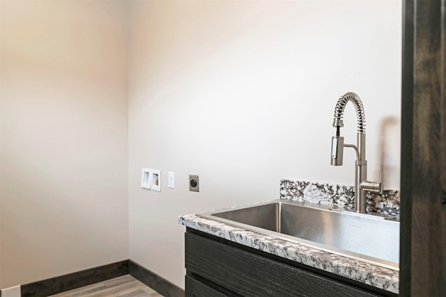 5576 Cattle Dr, Missoula, MT 59808 - washroom with electric dryer hookup, dark wood-style flooring, baseboards, and hookup for a washing machine