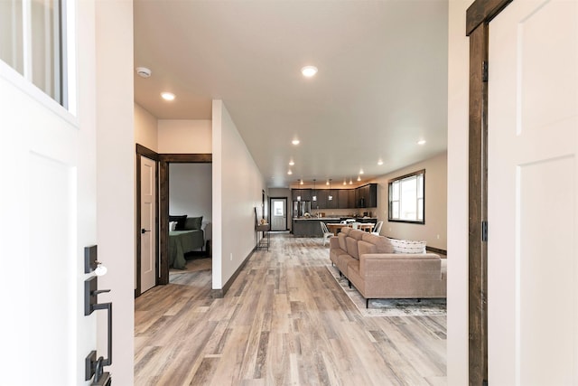 5576 Cattle Dr, Missoula, MT 59808 - living area featuring light wood finished floors, recessed lighting, and baseboards